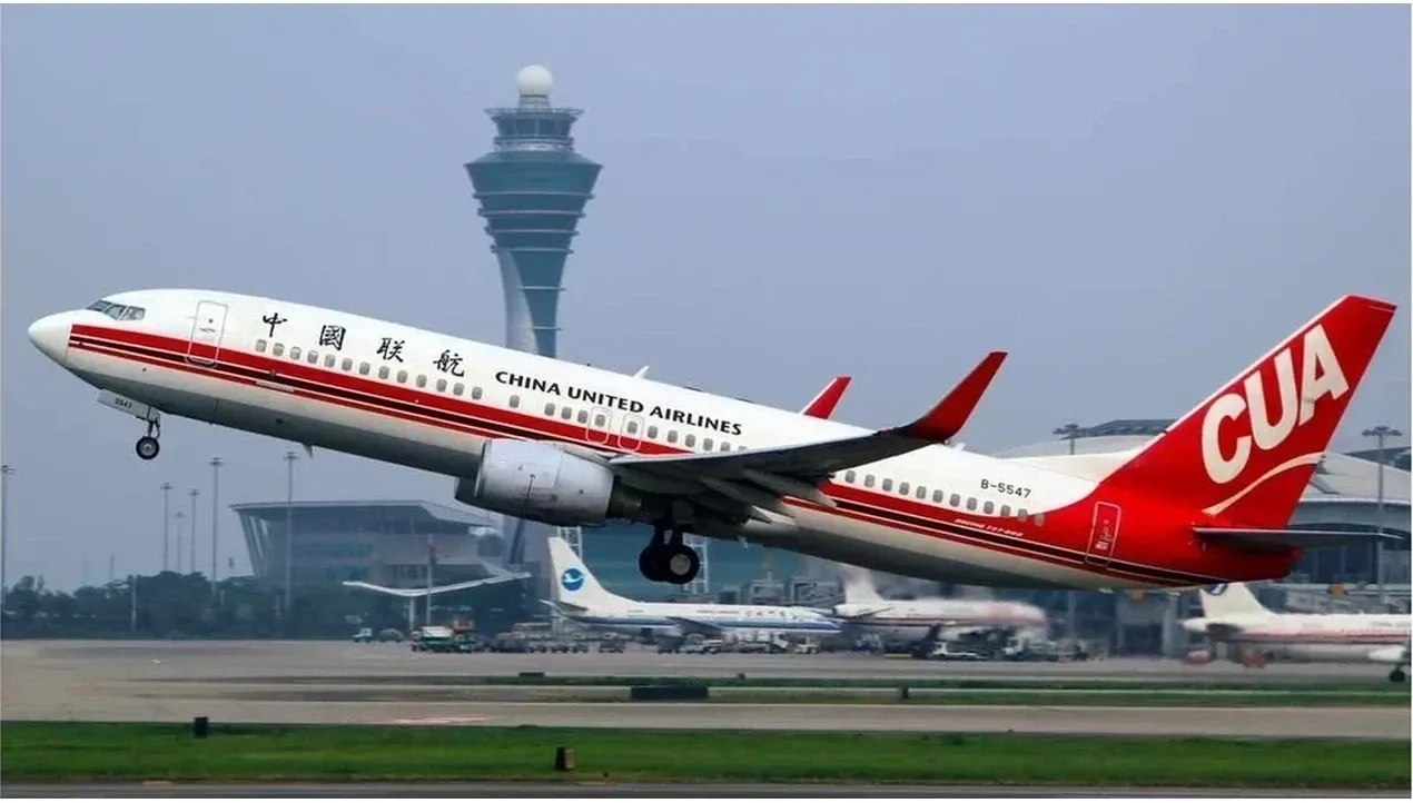 A United Airlines aircraft with red and white livery is taking off from a busy airport runway